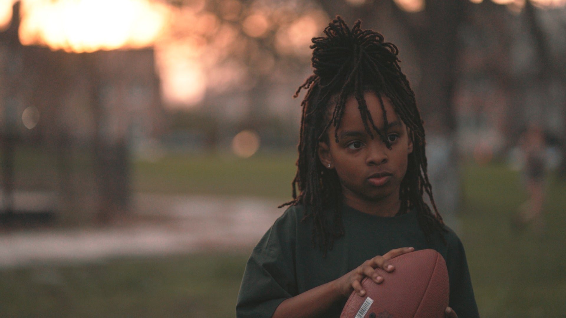 girl football golden hour green AVA tee