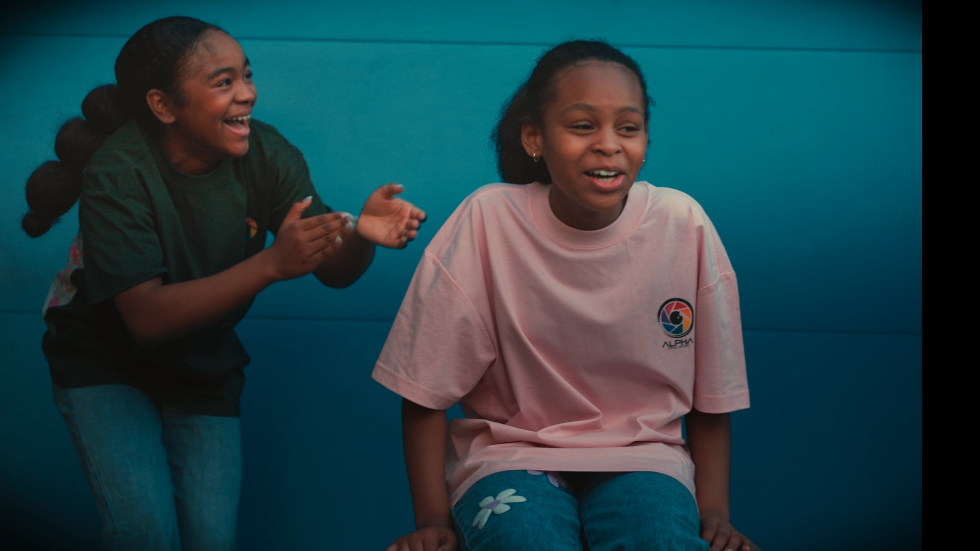 green pink tee duo teal wall